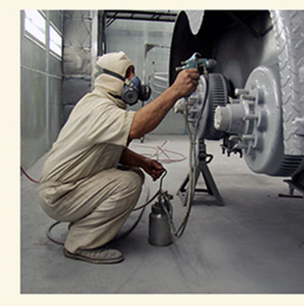 Offender painting a bus at the Ellis Unit in Huntsville