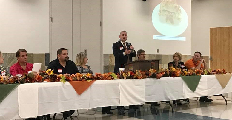 Photo of judges sitting at the head table.