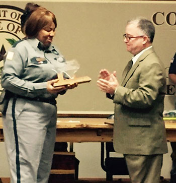 Photo of Kimberly Haney receiving the Valor Award from TDCJ Executive Director Bryan Collier
